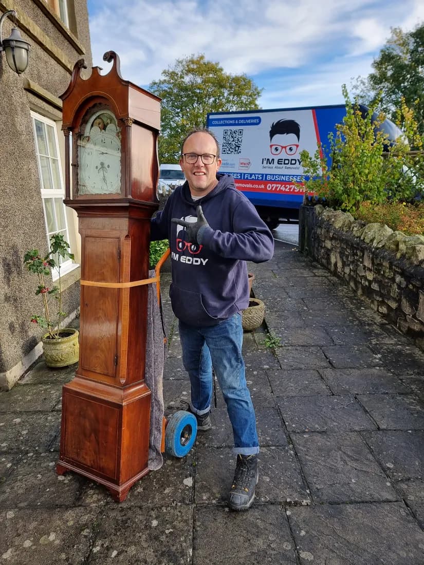 A grandfather clock wrapped and protected during a house clearance