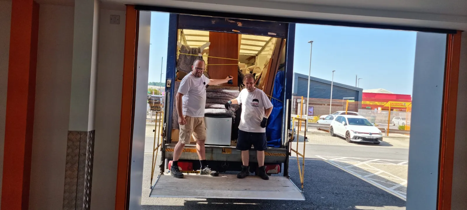 Two-person crew moving a large fridge safely